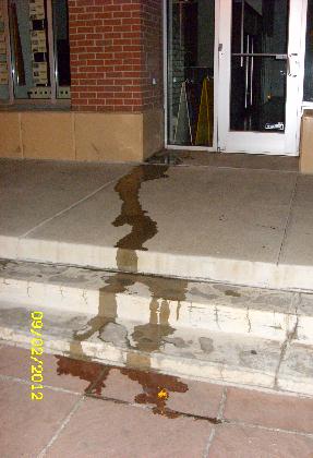 woman's huge piss puddle by doorway